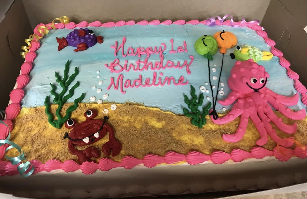 Under-the-sea first birthday sheet cake with buttercream octopus, crab and fish